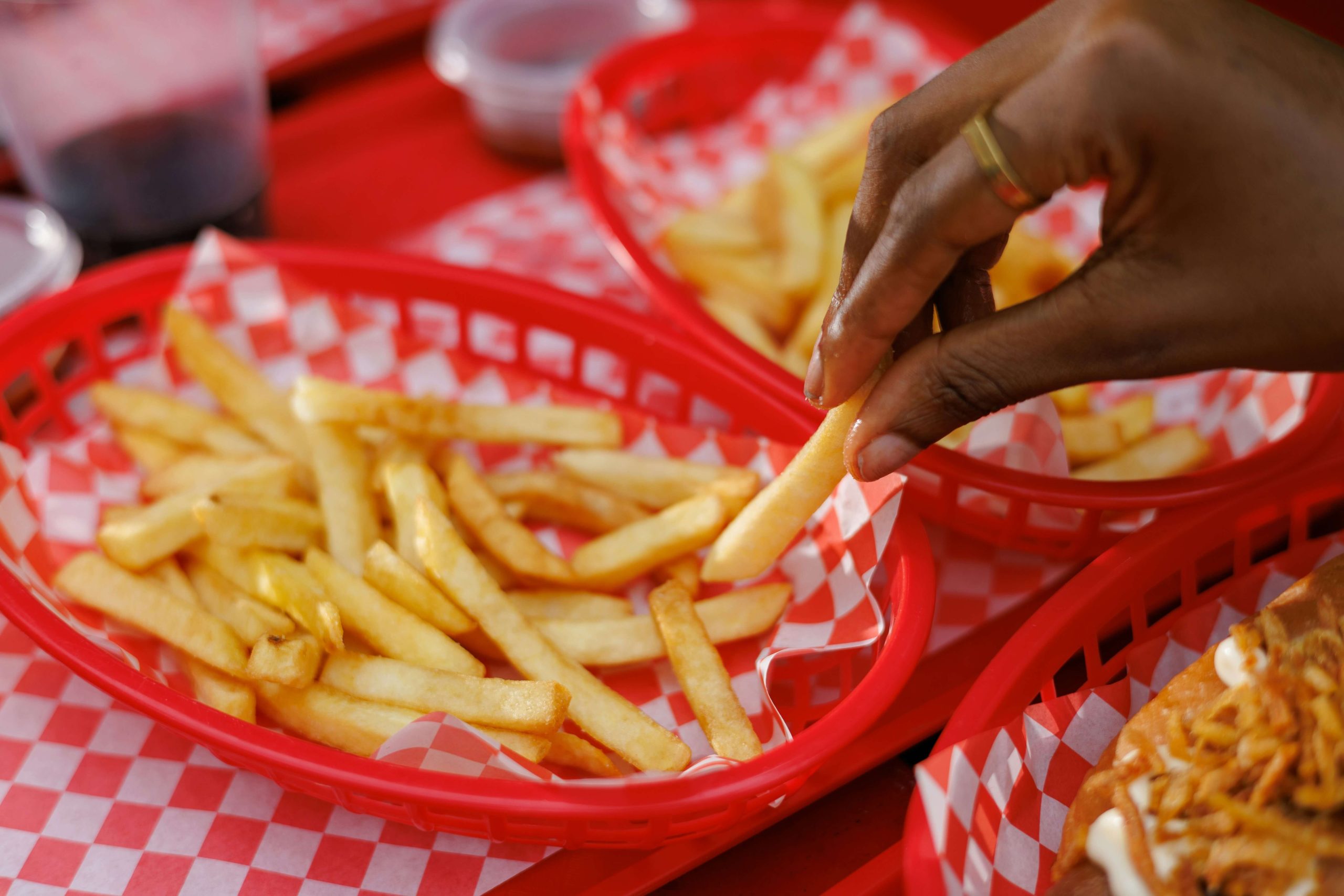 Fries being served in red plastic diner style basket, junk food ad ban